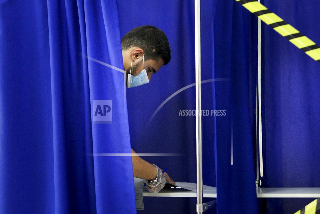 Musa Sadulayev A Chechen man reads his ballots in a voting booth at a polling station during the Parliamentary elections in Grozny, Russia, Saturday, Sept. 18, 2021. Sunday will be the last of three days voting for a new parliament, but there seems to be no expectation that United Russia, the party devoted to President Vladimir Putin, will lose its dominance in the State Duma. (AP Photo/Musa Sadulayev)