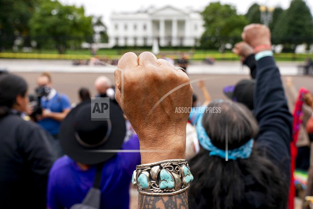 Andrew Harnik FILE - Wolf Ramerez of Houston, Texas, center, joins others with the Carrizo Comecrudo Tribe of Texas in holding up his fists as indigenous and environmental activists protest in front of the White House in Washington, Oct. 11, 2021. A U.S. Supreme Court ruling expanding state authority to prosecute some crimes on Native American land is upending decades of law in support of tribal sovereignty. (AP Photo/Andrew Harnik, File)