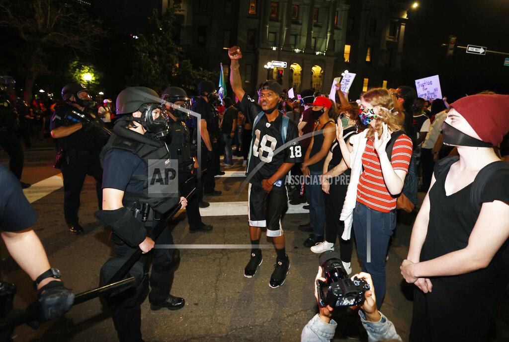 David Zalubowski Denver police face off with protesters outside the State Capitol over the death of George Floyd, a handcuffed black man in police custody in Minneapolis, Thursday, May 28, 2020, in Denver. (AP Photo/David Zalubowski)