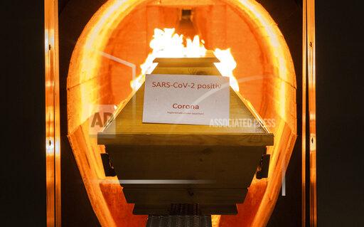 A coffin labelled with a paper 'SARS-CoV-2 positive - Corona' cremated in the crematorium in Giesen, Germany, Nov. 25, 2021. Germany’s disease control agency said it recorded 351 additional deaths in connection with the coronavirus over the past 24 hours, taking the total toll to 100,119. In Europe, Germany is the fifth country to pass that mark, after Russia, the United Kingdom, Italy and France. (Julian Stratenschulte/dpa via AP)