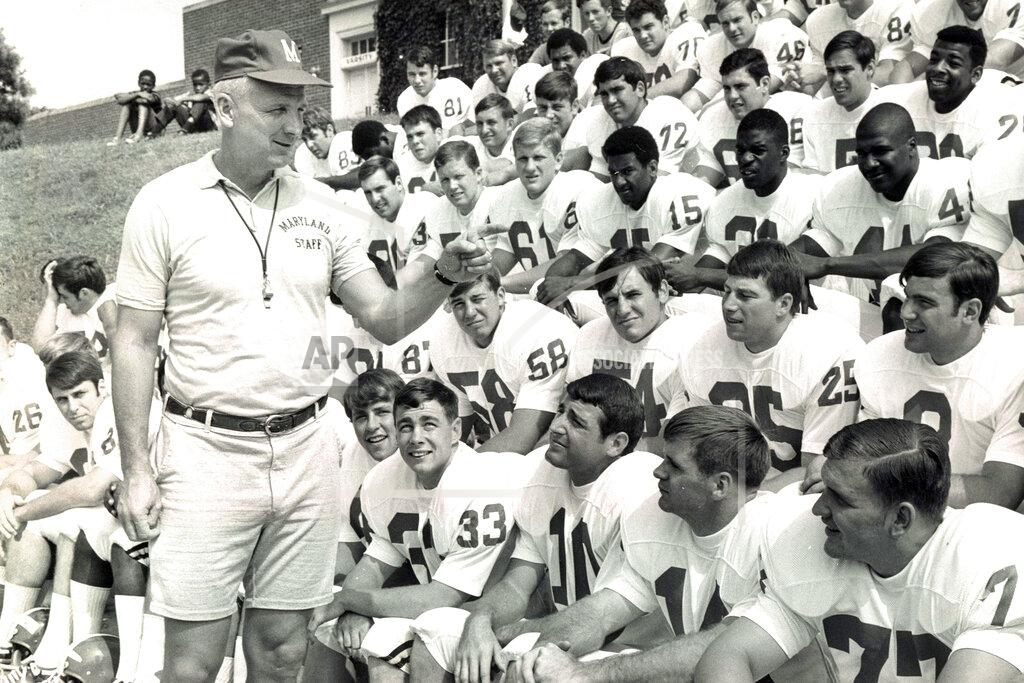 This Sept. 1, 1969, photo shows Maryland football coach Roy Lester greeting Maryland NCAA college football players on picture day in College Park, Md. Lester, who sandwiched a disappointing three-year stint as Terrapins coach between a highly successful career at the high school level, has died at the age of 96. His daughter, Amy Lester Greco, says her father died Sunday, May 3, ,3030, in Rockville, Maryland, due to complications from the new coronavirus. (Paul Hutchins/The Baltimore Sun via AP)