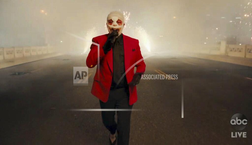 Uncredited In this screen shot provided by ABC on Sunday, Nov. 22, 2020, The Weeknd performs for the American Music Awards at the Microsoft Theater in Los Angeles. (ABC via AP)