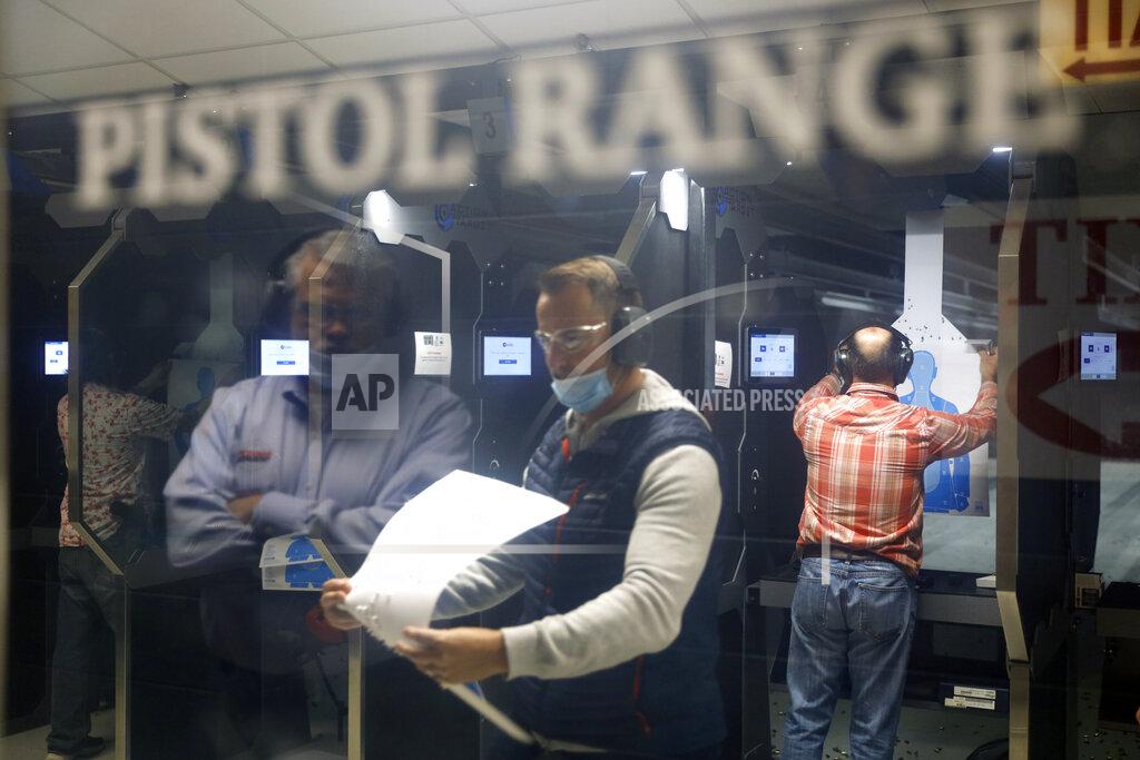 Shafkat Anowar Maxon Shooter's Supplies and Indoor Range owner Dan Eldridge is reflected on a glass door as he watches the shooters at the pistol range, Friday, April 30, 2021, in Des Plaines, Ill. After a year of pandemic lockdowns, mass shootings are back, but the guns never went away. As the U.S. inches toward a post-pandemic future, guns are arguably more present in the American psyche and more deeply embedded in American discourse than ever before. The past year's anxiety and loss fueled a rise in gun ownership across political and socio-economic lines. (AP Photo/Shafkat Anowar)