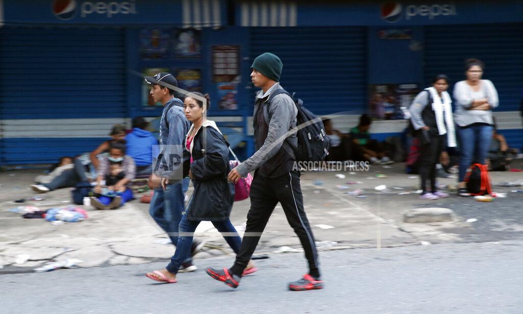 Moises Castillo Migrants walk and rest in Puerto Barrios, Guatemala, after crossing the border from Honduras, Friday, Oct. 2, 2020. Guatemala vowed to detain and return members of a new caravan of about 2,000 migrants that set out from neighboring Honduras in hopes of reaching the United States, saying they represent a health threat amid the coronavirus pandemic. (AP Photo/Moises Castillo)
