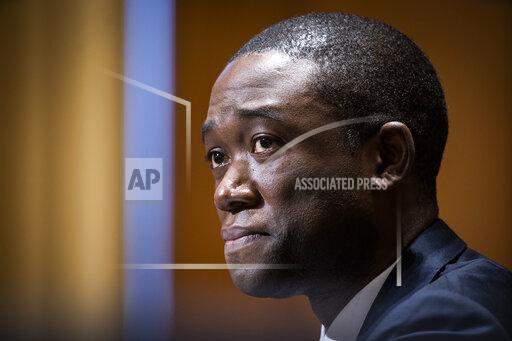 FILE - In this Feb. 23, 2021, file photo Wally Adeyemo testifies before the Senate Finance Committee during his confirmation hearing to be Deputy Secretary of the Treasury in Washington. The Biden administration took aim Tuesday, Sept. 21, at the financial marketplace for criminal ransomware gangs, announcing sanctions against a Russia-based virtual currency brokerage that officials say has processed illicit transactions for attackers. The goal of the action is to go after the “financial enablers” of ransomware gangs, Deputy Treasury Secretary Wally Adeyemo told reporters in previewing the announcement. (Jim Lo Scalzo/Pool via AP, File)