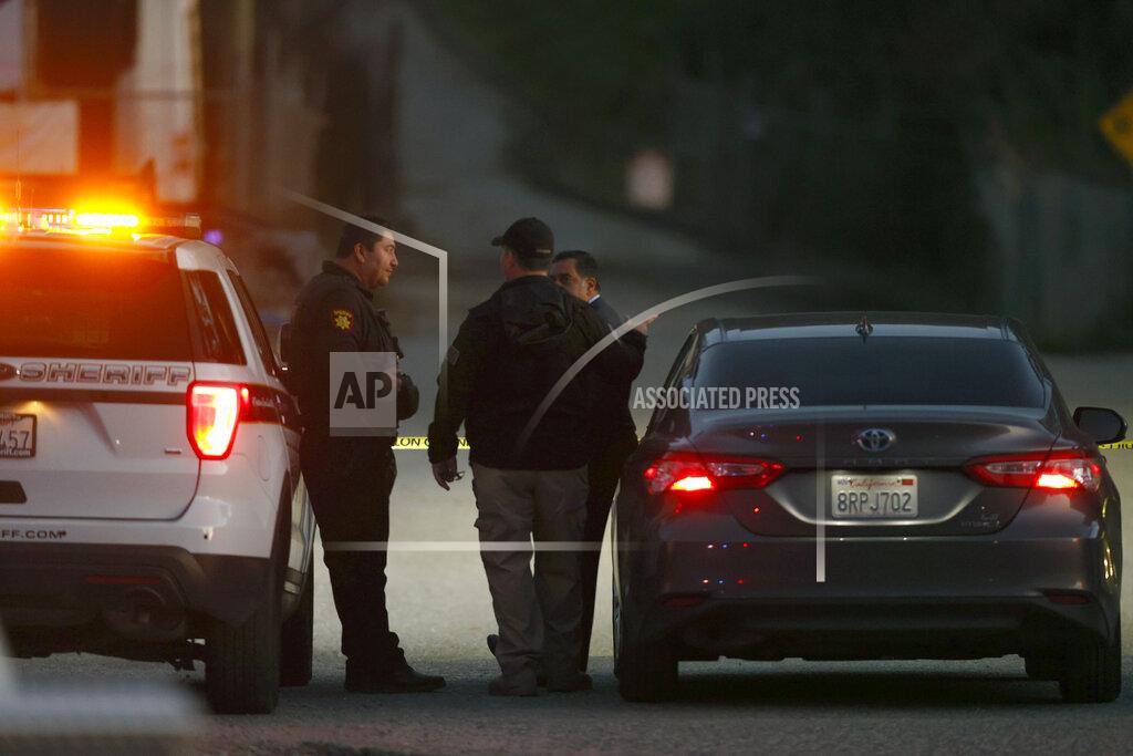Carlos Gonzalez San Mateo County Sheriffs officers and EMS personnel gather along a road at a location near where multiple people were found shot to death on Monday, Jan. 23, 2023, in Half Moon Bay, Calif. (Carlos Gonzalez/San Francisco Chronicle via AP)