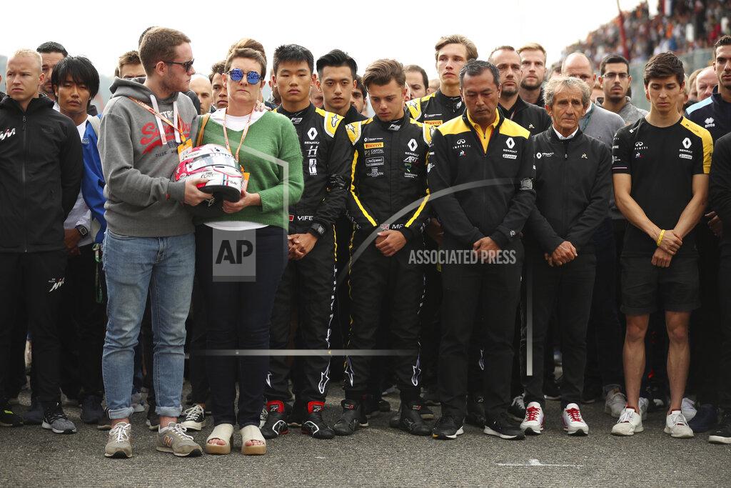Francisco Seco The mother and brother of Anthoine Hubert hold the helmet of Anthoine Hubert during a moment of silence at the Belgian Formula One Grand Prix circuit in Spa-Francorchamps, Belgium, Sunday, Sept. 1, 2019. The 22-year-old Hubert died following an estimated 160 mph (257 kph) collision on Lap 2 at the high-speed Spa-Francorchamps track, which earlier Saturday saw qualifying for Sunday's Formula One race. (AP Photo/Francisco Seco)