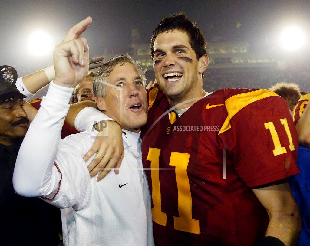 Kevork Djansezian FILE - In this Dec. 6, 2003, file photo, Southern California quarterback Matt Leinart, right, hugs head coach Pete Carroll as they celebrate their win over Orgeon State, 52-28, in Los Angeles. In the 80-year history of The Associated Press college football poll, no team has had a longer uninterrupted run at No. 1 than coach Pete Carroll’s Southern California Trojans. (AP Photo/Kevork Djansezian, File)