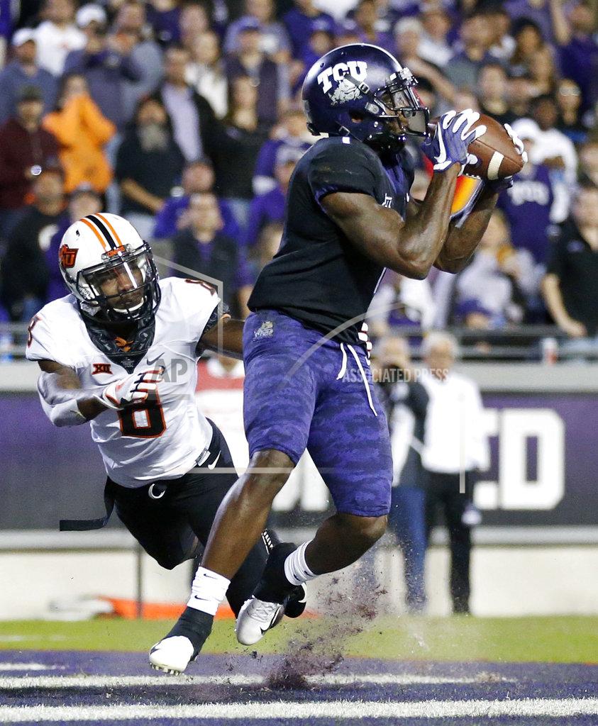 Tom Fox TCU wide receiver Jalen Reagor (1) pulls in a second-quarter touchdown reception in the end zone as Oklahoma State cornerback Rodarius Williams (8) defends during an NCAA college football game in Fort Worth, Texas, Saturday, Nov. 24, 2018. (Tom Fox/The Dallas Morning News via AP)