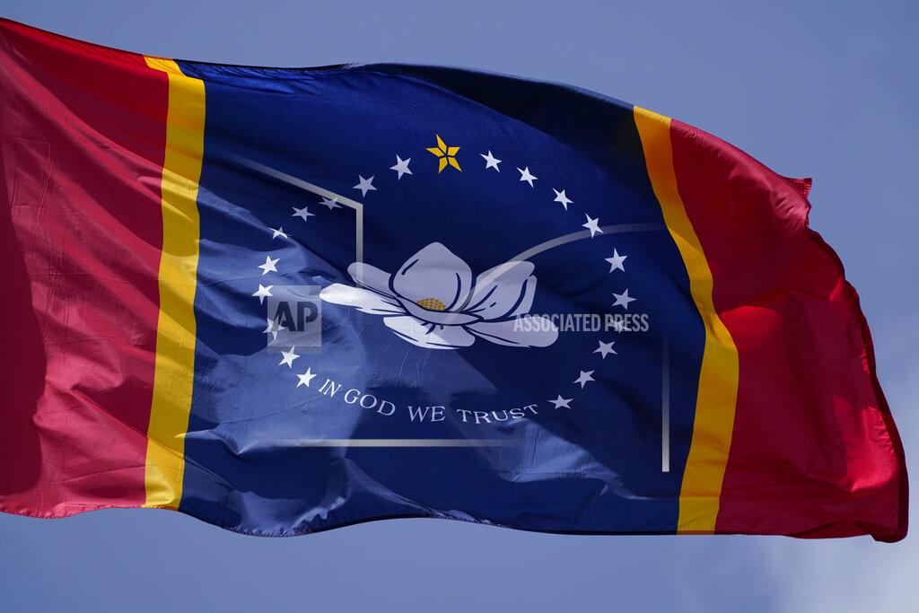 FILE - This Sept. 2, 2020 file photo shows the magnolia centered banner chosen by the Mississippi State Flag Commission displayed outside the Old State Capitol Museum in downtown Jackson, Miss. Voters approved the design in the general election on Tuesday, Nov. 3, 2020. It replaces a Confederate-themed flag state lawmakers retired in late June as part of the national reckoning over racial injustice. (AP Photo/Rogelio V. Solis, File)