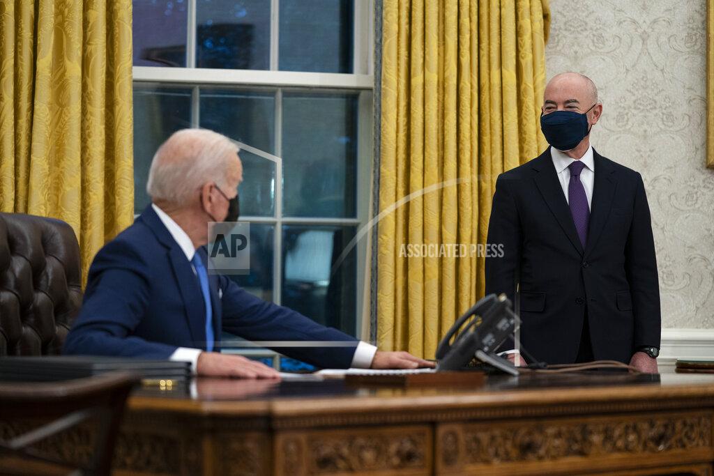 Evan Vucci Secretary of Homeland Security Alejandro Mayorkas listens as President Joe Biden speaks before signing an executive order on immigration, in the Oval Office of the White House, Tuesday, Feb. 2, 2021, in Washington. (AP Photo/Evan Vucci)