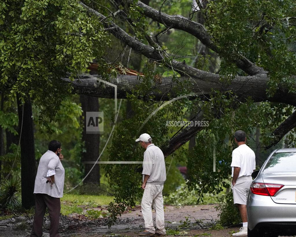 Rogelio V. Solis Neighbors inspect the wind toppled trees in this northeast Jackson, Miss., neighborhood, Tuesday, May 4, 2021. The severe weather was not unexpected, since the state was hit with a number of tornadoes on Sunday. (AP Photo/Rogelio V. Solis)