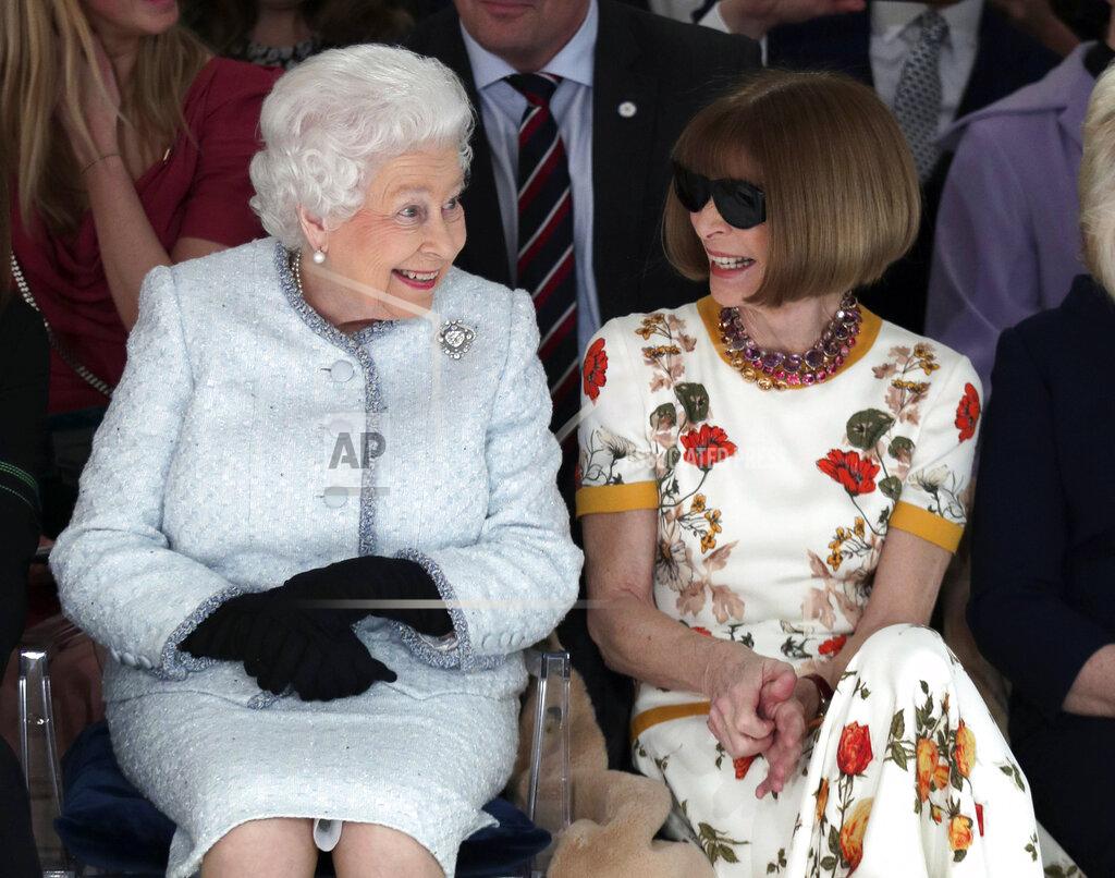 Yui Mok FILE - Britain's Queen Elizabeth sits next to Vogue fashion editor Anna Wintour as they view Richard Quinn's runway show before presenting him with the inaugural Queen Elizabeth II Award for British Design in central London on Feb. 20, 2018. (Yui Mok/Pool photo via AP)