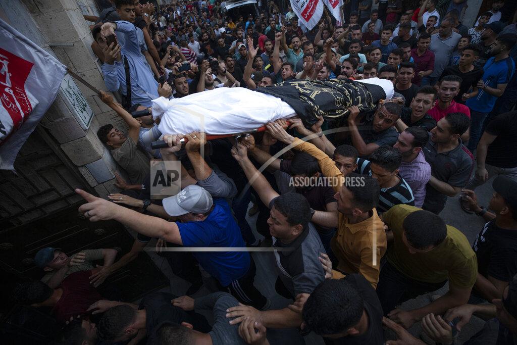 Fatima Shbair Palestinian mourners carry the bodies of victims killed earlier in an Israeli airstrike, during their funeral in Gaza City, Friday, Aug. 5, 2022. Palestinian officials say Israeli airstrikes on Gaza have killed several people, including a senior militant, and wounded 40 others. (AP Photo/Fatima Shbair)