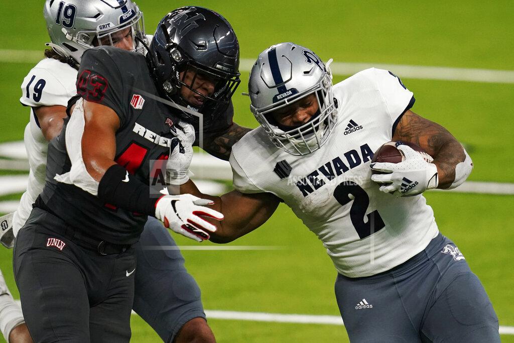 John Locher Nevada running back Devonte Lee (2) runs for a gain around UNLV linebacker Malakai Salu (43) during the first half of an NCAA college football game Saturday, Oct. 31, 2020, in Las Vegas. (AP Photo/John Locher)