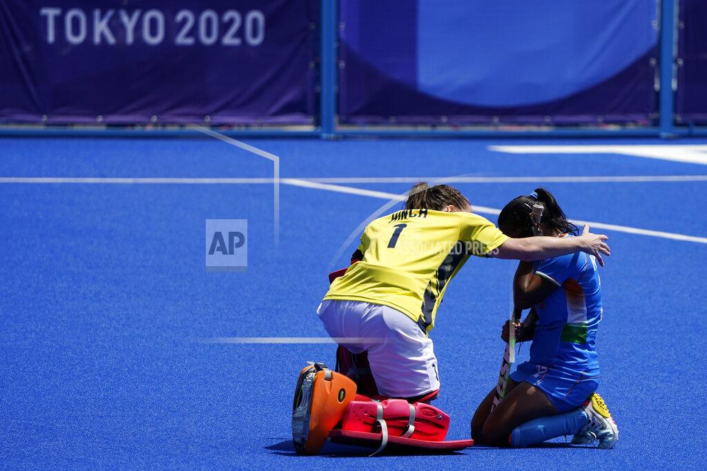 John Minchillo Britain's goalkeeper Claire Hinch (1) comforts India's Neha Neha, right, after winning their women's field hockey bronze medal match at the 2020 Summer Olympics, Friday, Aug. 6, 2021, in Tokyo, Japan. Britain won 4-3. (AP Photo/John Minchillo)
