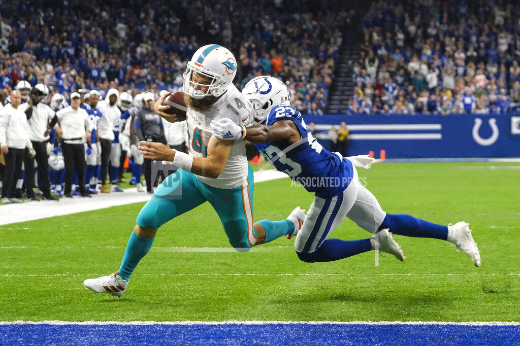 Aj Mast Miami Dolphins quarterback Ryan Fitzpatrick (14) breaks the tackle of Indianapolis Colts cornerback Kenny Moore (23) to score a touchdown during the first half of an NFL football game in Indianapolis, Sunday, Nov. 10, 2019. (AP Photo/AJ Mast)