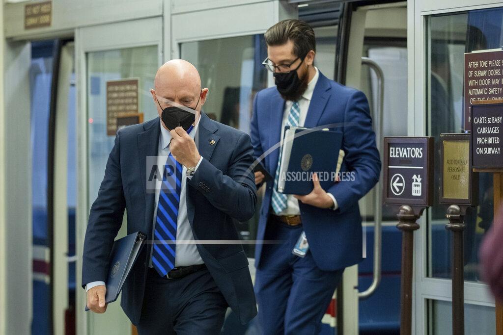 Amanda Andrade-Rhoades Sen. Mark Kelly, D-Ariz., adjusts his mask as he leaves the Senate subway on Capitol Hill in Washington, Tuesday, Aug. 3, 2021. (AP Photo/Amanda Andrade-Rhoades)