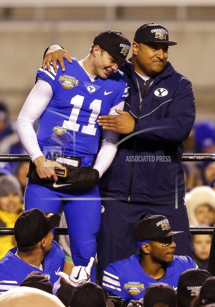 Steve Conner BYU head coach Kalani Sitake, top right, hugs BYU quarterback Zach Wilson (11) after winning the Famous Idaho Potato Bowl NCAA college basketball game against Western Michigan, Friday, Dec. 21, 2018, in Boise, Idaho. (AP Photo/Steve Conner)