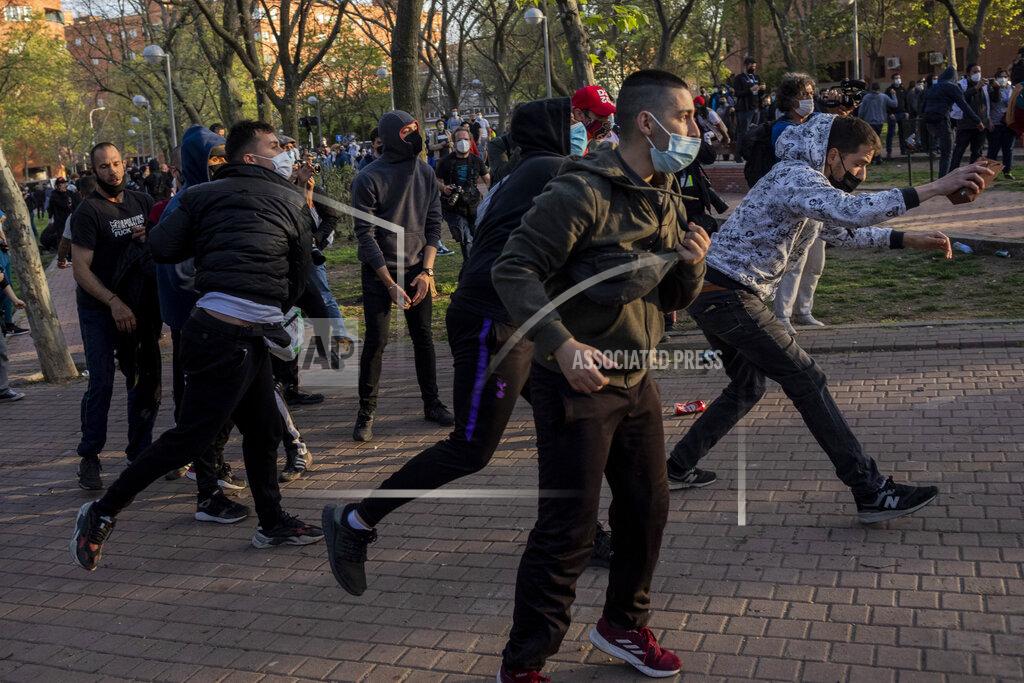 Bernat Armangue Left-wing protesters clash with police in Madrid's Vallecas neighborhood, Spain, Wednesday, April 7, 2021. Spanish police have used batons to keep protesters away from a campaign event of the far-right Vox party in Madrid. Scuffles started Wednesday when Santiago Abascal, the national leader of Vox, approached a crowd gathered to protest the party rally in Madrid's Vallecas neighborhood, a traditional left-wing bastion. Riot peace charged the bunches of protesters to keep them away from the party campaign event for upcoming regional elections. (AP Photo/Bernat Armangue)