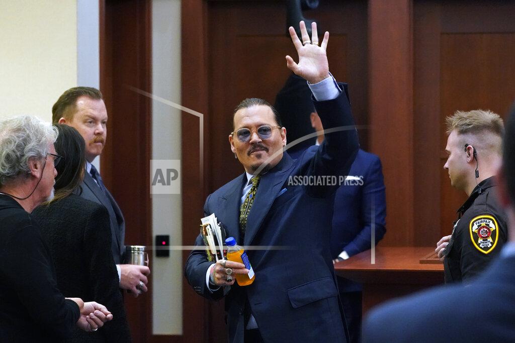 Steve Helber Actor Johnny Depp gestures to the gallery as he leaves for a break in the courtroom at the Fairfax County Circuit Courthouse in Fairfax, Va., Monday, May 23, 2022. Depp sued his ex-wife Amber Heard for libel in Fairfax County Circuit Court after she wrote an op-ed piece in The Washington Post in 2018 referring to herself as a "public figure representing domestic abuse." (AP Photo/Steve Helber, Pool)