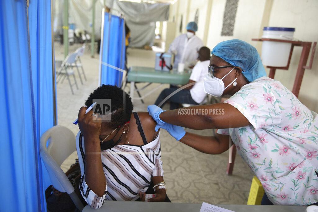 Joseph Odelyn A health worker injects a person with a dose of the Moderna vaccine for COVID-19 at Saint Damien Hospital in Port-au-Prince, Haiti, Tuesday, July 27, 2021. After months of not having any vaccines in the country, the U.S. donated 500,000 doses through the U.N. COVAX system for Haiti in mid-July. (AP Photo/Joseph Odelyn)