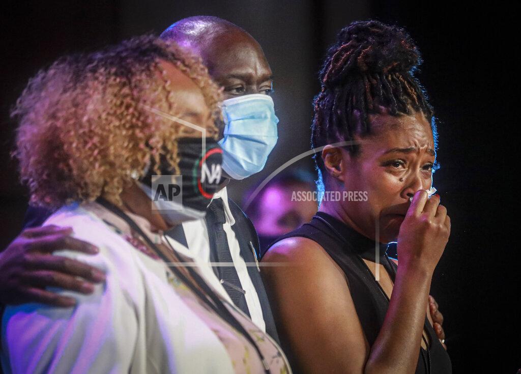Bebeto Matthews Actress Tiffany Haddish, right, wipes away tears as she stands with civil rights attorney Ben Crump and Eric Garner's mother Gwen Carr, at a memorial service for George Floyd at North Central University, on Thursday, June 4, 2020, in Minneapolis. The service — the first in a series of memorials set for three cities over six days — unfolded with Hollywood celebrities, musicians and political leaders pay their respects in front of the golden casket of George Floyd, the man whose death at the hands of police sparked global protests. (AP Photo/Bebeto Matthews)