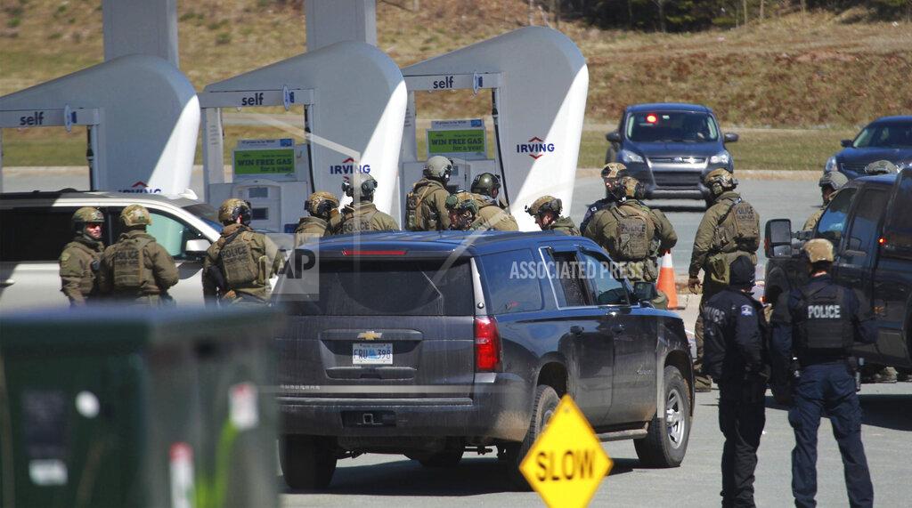 Tim Krochak Royal Canadian Mounted Police officers prepare to take a suspect at a gas station in Enfield, Nova Scotia, Sunday April 19, 2020. Canadian police say multiple people are dead plus the suspect after a shooting rampage across the province of Nova Scotia. It was the deadliest shooting in Canada in 30 years. (Tim Krochak/The Canadian Press via AP)