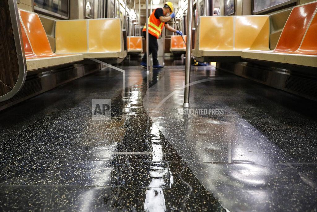 John Minchillo A contractor cleans a subway car at the 96th Street station to control the spread of COVID-19, Thursday, July 2, 2020, in New York. Mass transit systems around the world have taken unprecedented — and expensive — steps to curb the spread of the coronavirus, including shutting down New York subways overnight and testing powerful ultraviolet lamps to disinfect seats, poles and floors. (AP Photo/John Minchillo)