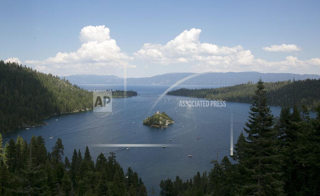Rich Pedroncelli FILE - In this Aug. 8. 2017 file photo, boats ply the waters of Emerald Bay of Lake Tahoe, near South Lake Tahoe, Calif. With wildfire no longer threatening Lake Tahoe, residents, tourists and scientists drawn to its clean alpine air, clear blue waters and fragrant pine trees now wonder about the long-term effects that will remain after wildfire season ends. (AP Photo/Rich Pedroncelli, File)