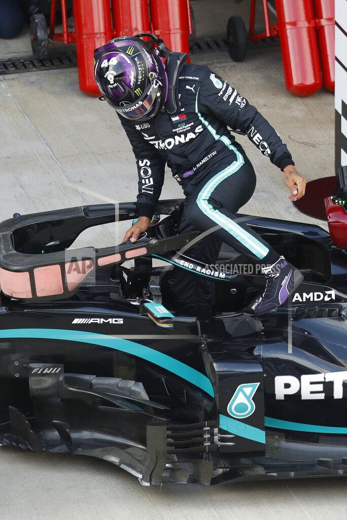 Pavel Golovkin FILE - In this file photo dated Saturday, Sept. 26, 2020, Mercedes driver Lewis Hamilton of Britain steps out of his car after clocking the fastest time during qualifying for the Russian Formula One Grand Prix, at the Sochi Autodrom circuit, in Sochi, Russia. Victory at the Portuguese Grand Prix on upcoming Sunday Oct. 25, 2020, would move the British driver onto 92 wins, and surpass the German great Michael Schumacher's mark of 91 that for so long within F1 had been considered untouchable. (AP Photo/Pavel Golovkin, Pool)