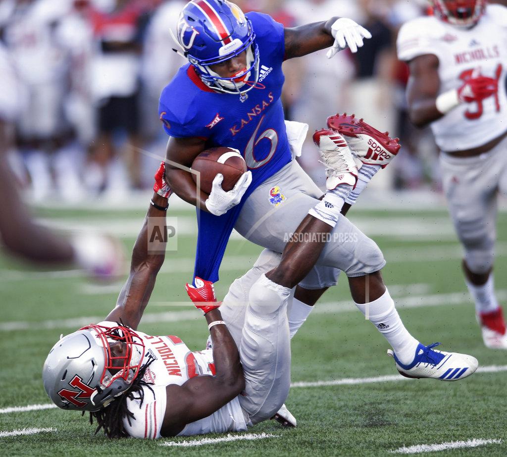 Reed Hoffmann Nicholls State defensive back Jonavon Lewis (27) pulls down Kansas wide receiver Quan Hampton (6) during the first quarter of an NCAA college football game in Lawrence, Kan., Saturday, Sept. 1, 2018. (AP Photo/Reed Hoffmann)