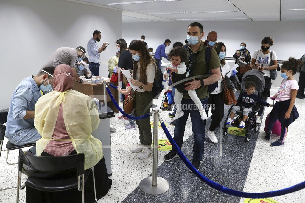Bilal Hussein Passengers wait in line to fill a document to undergo a PCR test at the Rafik Hariri International Airport in Beirut, Lebanon, Wednesday, July 1, 2020. Beirut's airport is partially reopening after a three-month shutdown and Lebanon's cash-strapped government is hoping that thousands of Lebanese expatriates will return for the summer, injecting dollars into the country's sinking economy. (AP Photo/Bilal Hussein)Hussein)