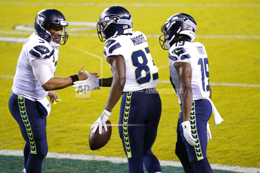 Chris Szagola Seattle Seahawks' David Moore (83) celebrates with Russell Wilson (3) and Penny Hart (19) after scoring a touchdown during the first half of an NFL football game against the Philadelphia Eagles, Monday, Nov. 30, 2020, in Philadelphia. (AP Photo/Chris Szagola)