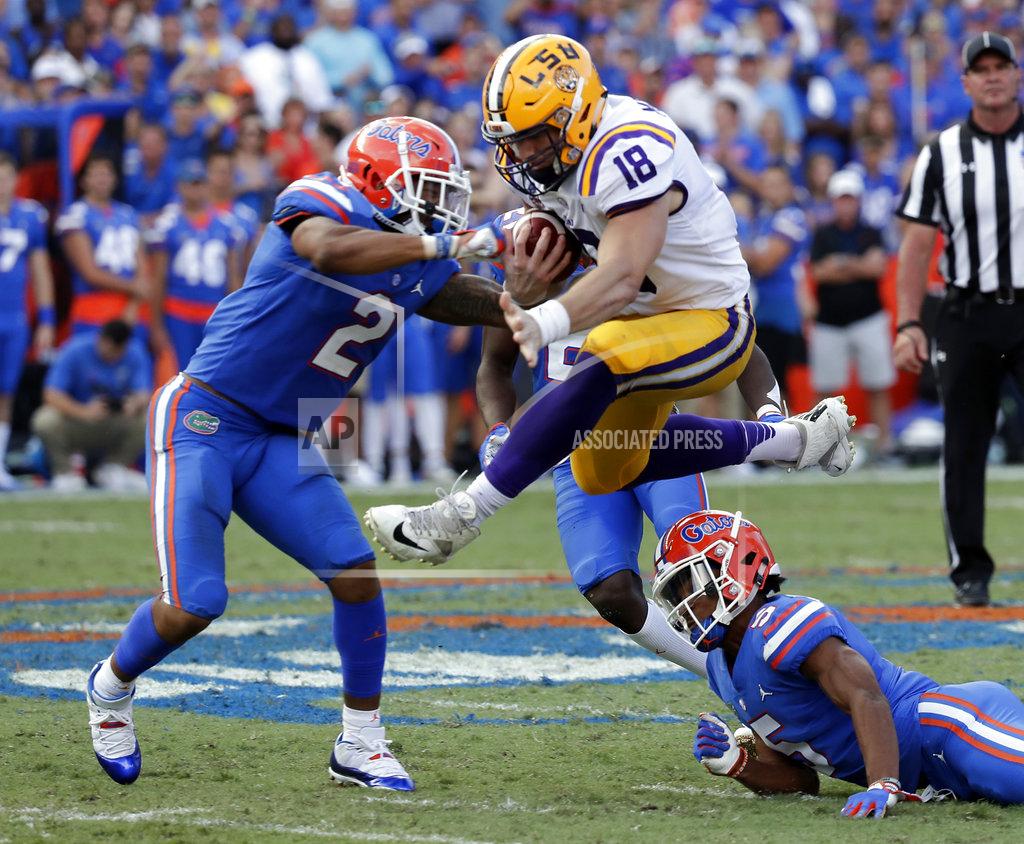 John Raoux LSU tight end Foster Moreau (18) leaps between Florida defensive back Brad Stewart Jr. (2) and defensive back CJ Henderson, lower right, after a reception during the second half of an NCAA college football game Saturday, Oct. 6, 2018, in Gainesville, Fla. (AP Photo/John Raoux)