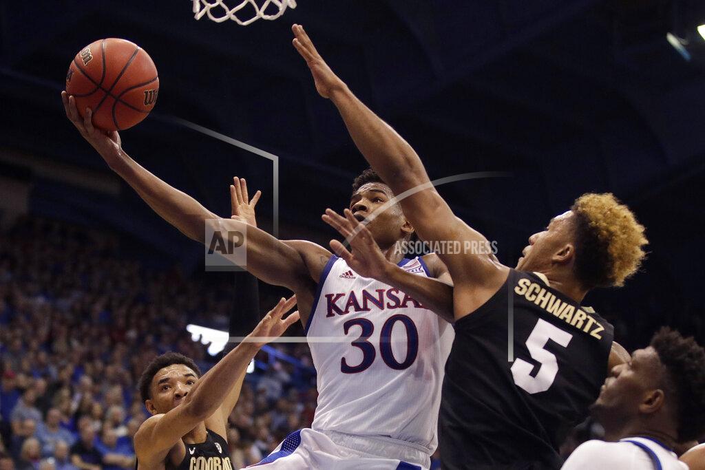 Charlie Riedel Kansas' Ochai Agbaji (30) gets past Colorado's D'Shawn Schwartz (5) to shoot during the first half of an NCAA college basketball game Saturday, Dec. 7, 2019, in Lawrence, Kan. (AP Photo/Charlie Riedel)
