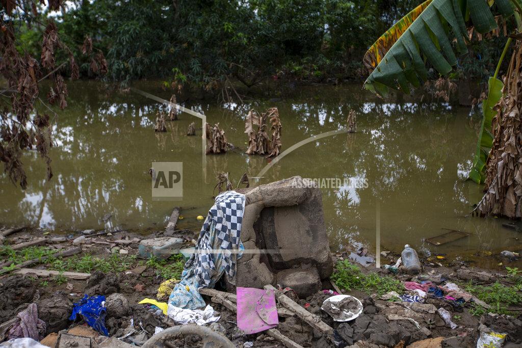 Moises Castillo Floodwaters brought by last year's hurricanes Eta and Iota continue to stand in the Saviñon Cruz neighborhood where people's homes were destroyed in San Pedro Sula, Honduras, Tuesday, Jan. 12, 2021. San Pedro Sula is Honduras’ economic engine and the departure gate for thousands of Honduran migrants in recent years who are caught in a cycle of migration. (AP Photo/Moises Castillo)