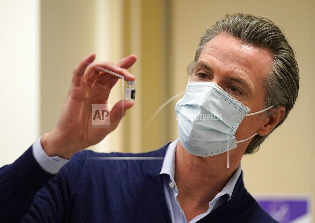 Jae Hong FILE - In this Dec. 14, 2020, file photo, California Gov. Gavin Newsom holds up a vial of the Pfizer COVID-19 vaccine at Kaiser Permanente Los Angeles Medical Center in Los Angeles. Newsom and his Democratic allies launched a campaign committee Monday, March 15, 2021, to stop a proposed recall election that could oust him from office. (AP Photo/Jae C. Hong, File)