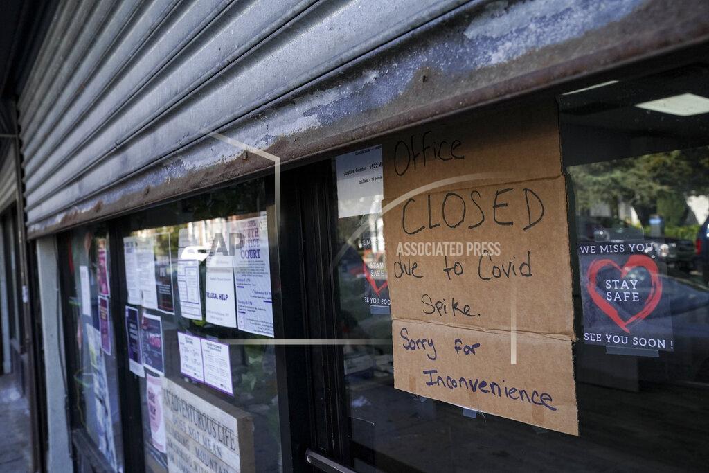 John Minchillo A storefront displays a closed sign as it remains shuttered due to a COVID-19 area infection rate increase, Thursday, Oct. 15, 2020, in the Far Rockaway neighborhood of the borough of Queens in New York. After shutdowns swept entire nations during the first surge of the coronavirus earlier this year, some countries and U.S. states are trying more targeted measures as cases rise again around the world. New York’s new round of shutdowns zeroes in on individual neighborhoods, closing schools and businesses in hot spots measuring just a few square miles. (AP Photo/John Minchillo)