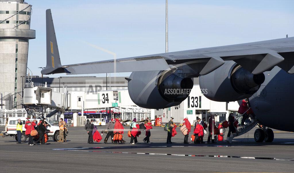 Mark Baker Staff board a U.S. Air Force C-17 as they prepare to take the season's first flight to McMurdo Station in Antarctica from Christchurch Airport, New Zealand, Monday, Sept. 14, 2020. The first U.S. flight into Antarctica following months of winter darkness left from New Zealand Monday with crews extra vigilant about keeping out the coronavirus. (AP Photo/Mark Baker)