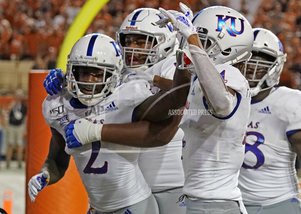Chuck Burton Kansas' Daylon Charlot (2) celebrates with teammates after catching a 2-point conversion during the second half of the team's NCAA college football game against Texas in Austin, Texas, Saturday, Oct. 19, 2019. (AP Photo/Chuck Burton)