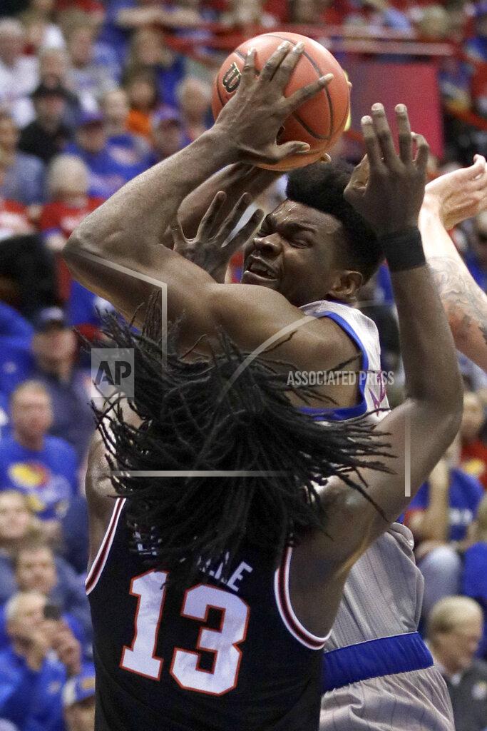 Orlin Wagner Kansas center Udoka Azubuike, back, rebounds over Oklahoma State guard Isaac Likekele (13) during the first half of an NCAA college basketball game in Lawrence, Kan., Monday, Feb. 24, 2020. (AP Photo/Orlin Wagner)