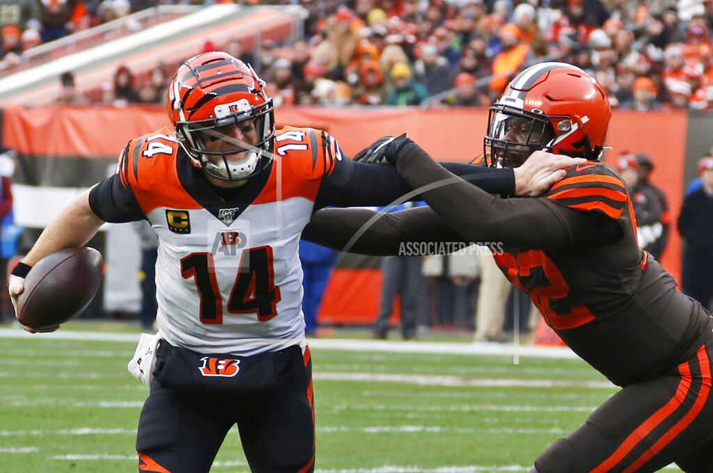 Ron Schwane Cincinnati Bengals quarterback Andy Dalton (14) scrambles past Cleveland Browns defensive end Chad Thomas (92) during the second half of an NFL football game, Sunday, Dec. 8, 2019, in Cleveland. (AP Photo/Ron Schwane)