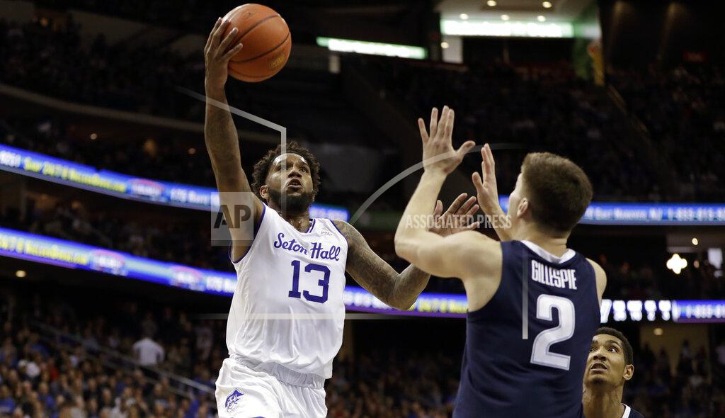 Kathy Willens Seton Hall guard Myles Powell (13) goes up for a layup against Villanova guard Collin Gillespie (2) and forward Jermaine Samuels, lower right, during the second half of an NCAA college basketball game, Saturday, March 9, 2019, in Newark, N.J. Seton Hall defeated Villanova 79-75. (AP Photo/Kathy Willens)