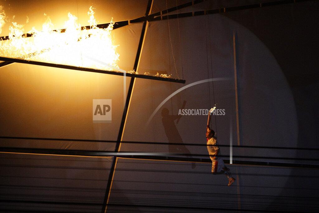 Julie Jacobson Li Ning lights the Olympic Torch during the opening ceremony for the Beijing 2008 Olympics in Beijing, Friday, Aug. 8, 2008. (AP Photo/Julie Jacobson)