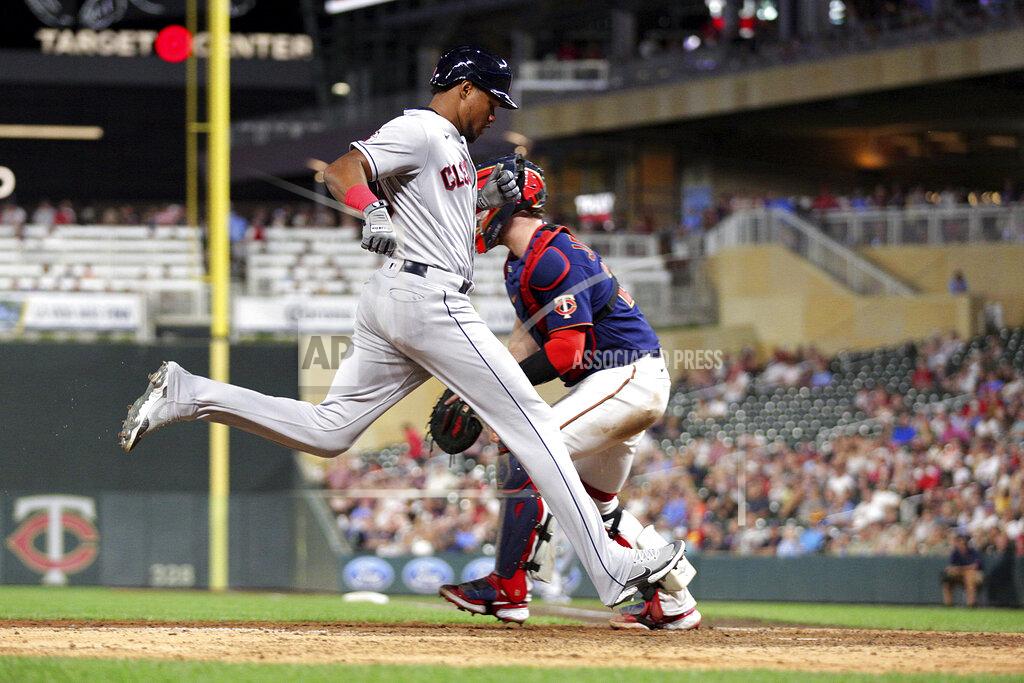 Andy Clayton-King Cleveland Guardians' Oscar Gonzalez scores next to Minnesota Twins catcher Ryan Jeffers during the ninth inning of a baseball game Wednesday, June 22, 2022, in Minneapolis. (AP Photo/Andy Clayton-King)