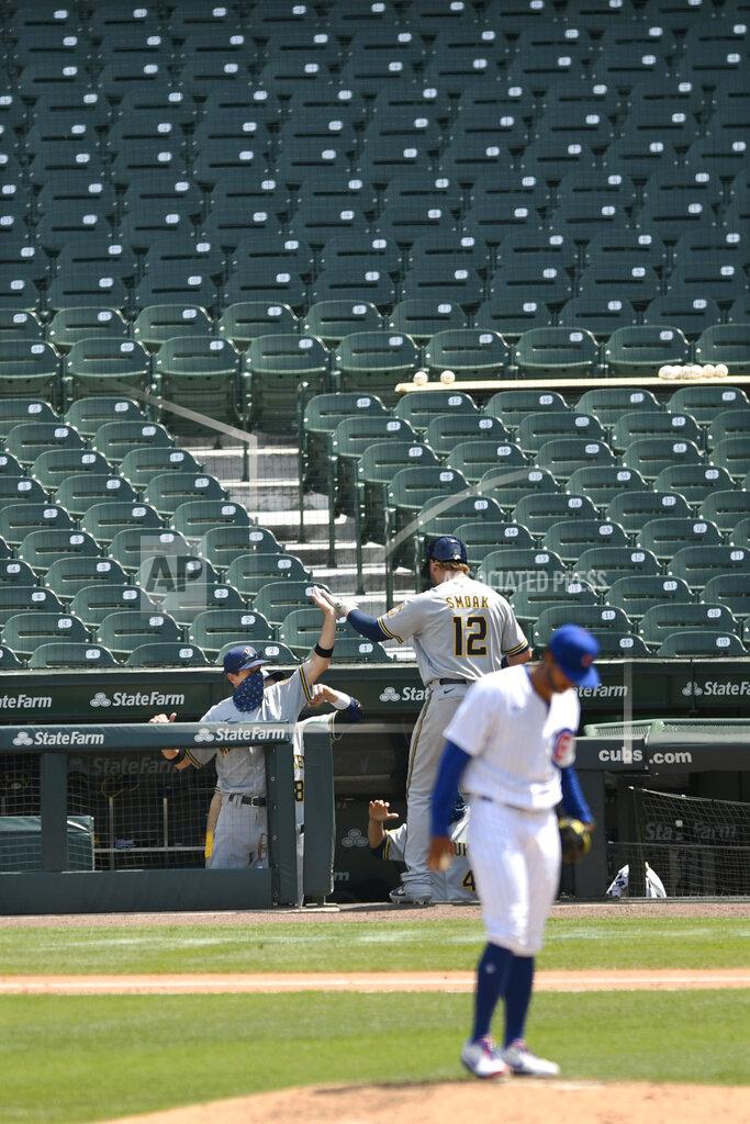 Paul Beaty Milwaukee Brewers manager Craig Counsell left, celebrates with Justin Smoak (12) at the dugout after he hit a solo home run during the fifth inning of a baseball game against the Chicago Cubs Saturday, July 25, 2020, in Chicago. (AP Photo/Paul Beaty)