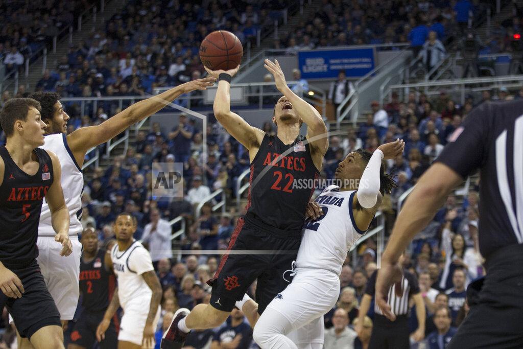 Tom R. Smedes San Diego State guard Malachi Flynn (22)shoots over Nevada guard Jazz Johnson (22) during the first half of an NCAA college basketball game played at Lawlor Events Center in Reno, Nev., Saturday, Feb. 29, 2020. (AP Photo/Tom R. Smedes)