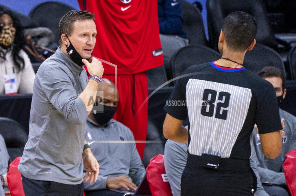 Chris Szagola Washington Wizards head coach Scott Brooks, left, reacts to referee Suyash Mehta, right, during the second half of an NBA basketball game against the Philadelphia 76ers, Wednesday, Jan. 6, 2021, in Philadelphia. The 76ers won 141-136. (AP Photo/Chris Szagola)
