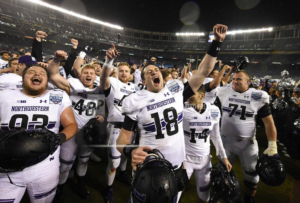 Denis Poroy Northwestern quarterback Clayton Thorson (18), and teammates celebrate after defeating Utah in the Holiday Bowl NCAA college football game Monday, Dec. 31, 2018, in San Diego. (AP Photo/Denis Poroy)